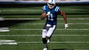 Michael Pittman Jr Runningon Field Wallpaper