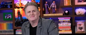 Michael Rapaport Striking A Confident Pose On A Dramatic Dark Background Wallpaper