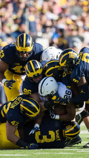 Michigan Wolverines Football Team In Action Wallpaper