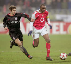 Midfielder_ Dribbling_ Past_ Defender_ Football_ Match Wallpaper