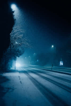 Midnight_ Snowfall_on_ City_ Street Wallpaper