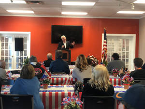 Mike Gibbons In Conference With Flag-like Tables Wallpaper