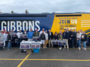 Mike Gibbons Interacting With People By The Bus Wallpaper