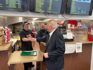 Mike Gibbons Shaking Hands With Employee Wallpaper