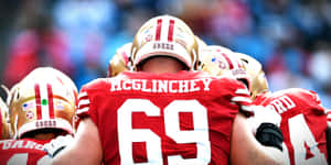 Mike Mcglinchey Making A Powerful Move On The Football Field Wallpaper