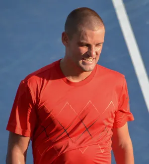 Mikhail Youzhny In Action - The Russian Tennis Maestro In Red Wallpaper
