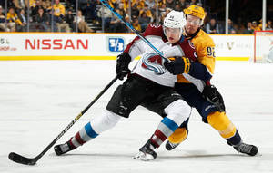 Mikko Rantanen Leaning And Falling Against Player From Nashville Predators Wallpaper