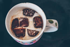 Milk Swirling Into A Cup Of Coffee Wallpaper