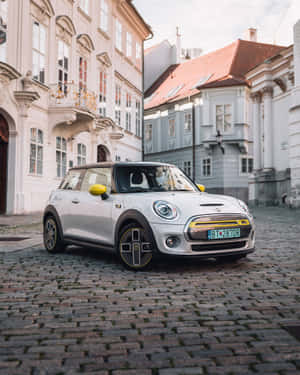 Mini Cooper S E Electric Parkedon Cobblestone Street Wallpaper