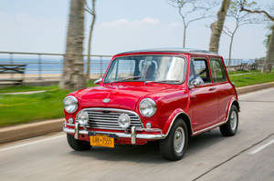 Mini Red Aesthetic Driving On Road Wallpaper