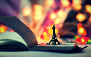 Miniature Eiffel Towerand Book Wallpaper