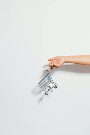 Miniature Shopping Cart Heldby Hand Wallpaper