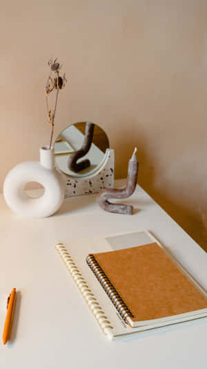 Minimalist Desk Setupwith Notebookand Decor Wallpaper