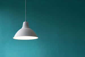 Minimalist Pendant Light Against Teal Background Wallpaper