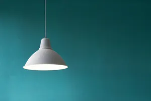 Minimalist Pendant Light Against Teal Background Wallpaper
