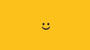 Minimalist Smiling Emoji In Mustard Background Wallpaper