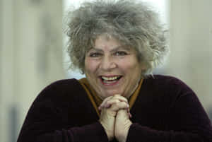 Miriam Margolyes Smiling In Elegant Dress Wallpaper