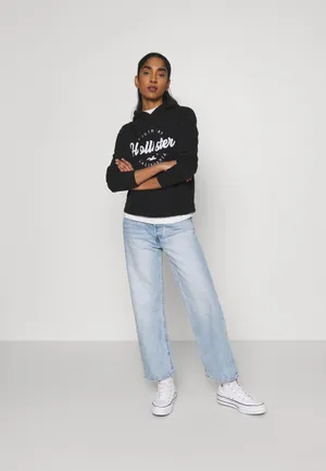 Model In Black Hollister Hoodie Wallpaper