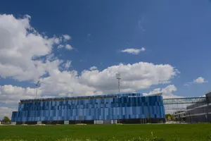 Modern Blue Building Under Cloudy Sky Wallpaper
