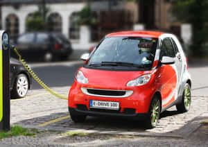 Modern Electric Vehicle Charging At A Station Wallpaper