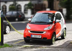 Modern Electric Vehicle Charging At A Station Wallpaper
