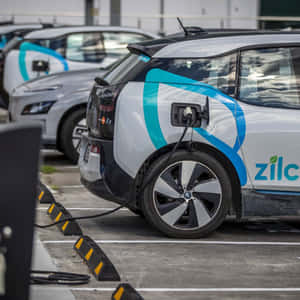 Modern Electric Vehicle Charging At A Station Wallpaper