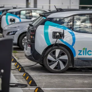 Modern Electric Vehicle Charging At A Station Wallpaper