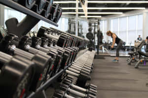 Modern Gym Interiorwith Dumbbell Rack Wallpaper