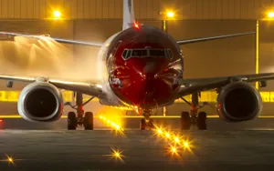 Modern Passenger Aircraft Flying Through The Sky Wallpaper