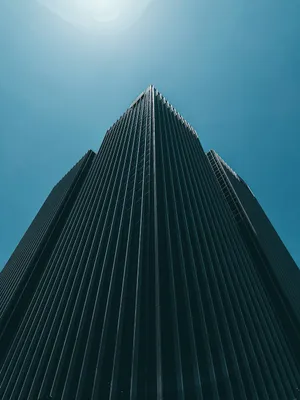 Modern_ Skyscraper_ Against_ Blue_ Sky Wallpaper