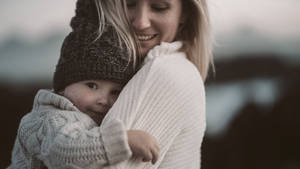 Mom Carrying Baby Wallpaper