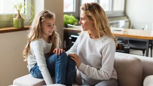 Mom Sitting With Girl Wallpaper
