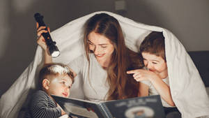 Mom Under Blanket Wallpaper