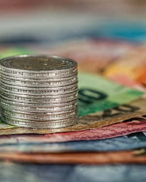 Money Paper And Stacked Coins Wallpaper