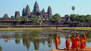 Monks Outside Angkor Wat In Cambodia Wallpaper