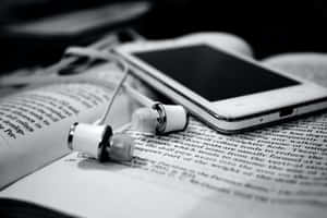 Monochrome Image Of An Open Book On A Wooden Surface Wallpaper