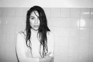 Monochrome Portraitof Woman Against Tiles Wallpaper