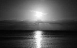 Monochrome_ Sunrise_ Over_ Calm_ Sea Wallpaper