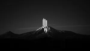 Monolithic_ Structure_on_ Snowy_ Mountain_ Peak_4 K Wallpaper