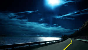 Moonlit_ Highway_by_the_ Sea Wallpaper