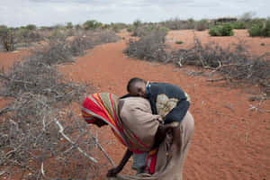 Mother And Child Needing Humanitarian Assistance Wallpaper