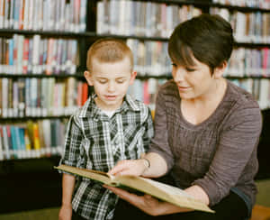 Motherand Son Reading Together Library Wallpaper