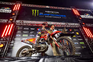 Motocross Champion Celebrationat Night Wallpaper