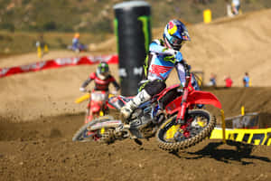 Motocross Racer Cornering Action Wallpaper