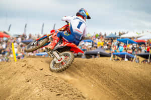 Motocross Racer Jumps Dirt Track Wallpaper