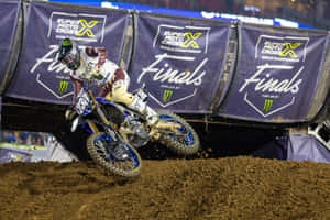 Motocross Rider Actionat Supercross Finals Wallpaper