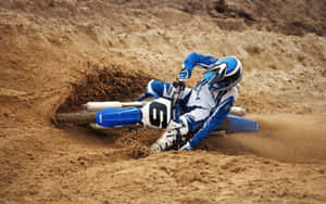 Motocross Rider Corneringin Sand.jpg Wallpaper