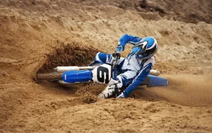 Motocross Rider Corneringin Sand.jpg Wallpaper