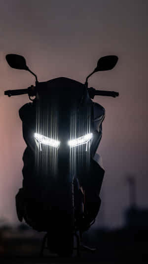 Motorcycle Headlight Illuminationat Dusk Wallpaper