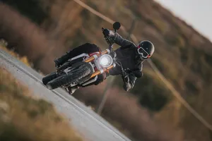 Motorcyclistin Actionon Curved Road.jpg Wallpaper